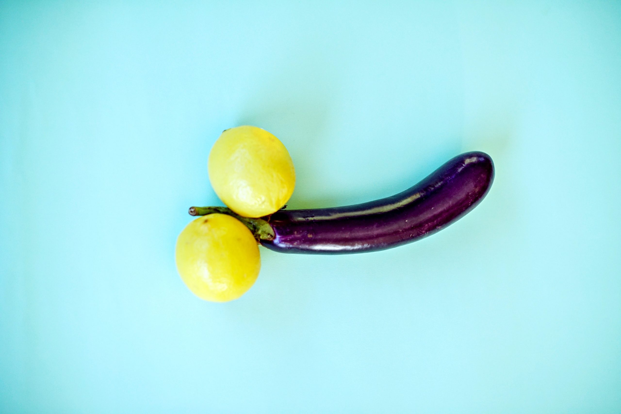 yellow lemon fruit beside yellow round fruit